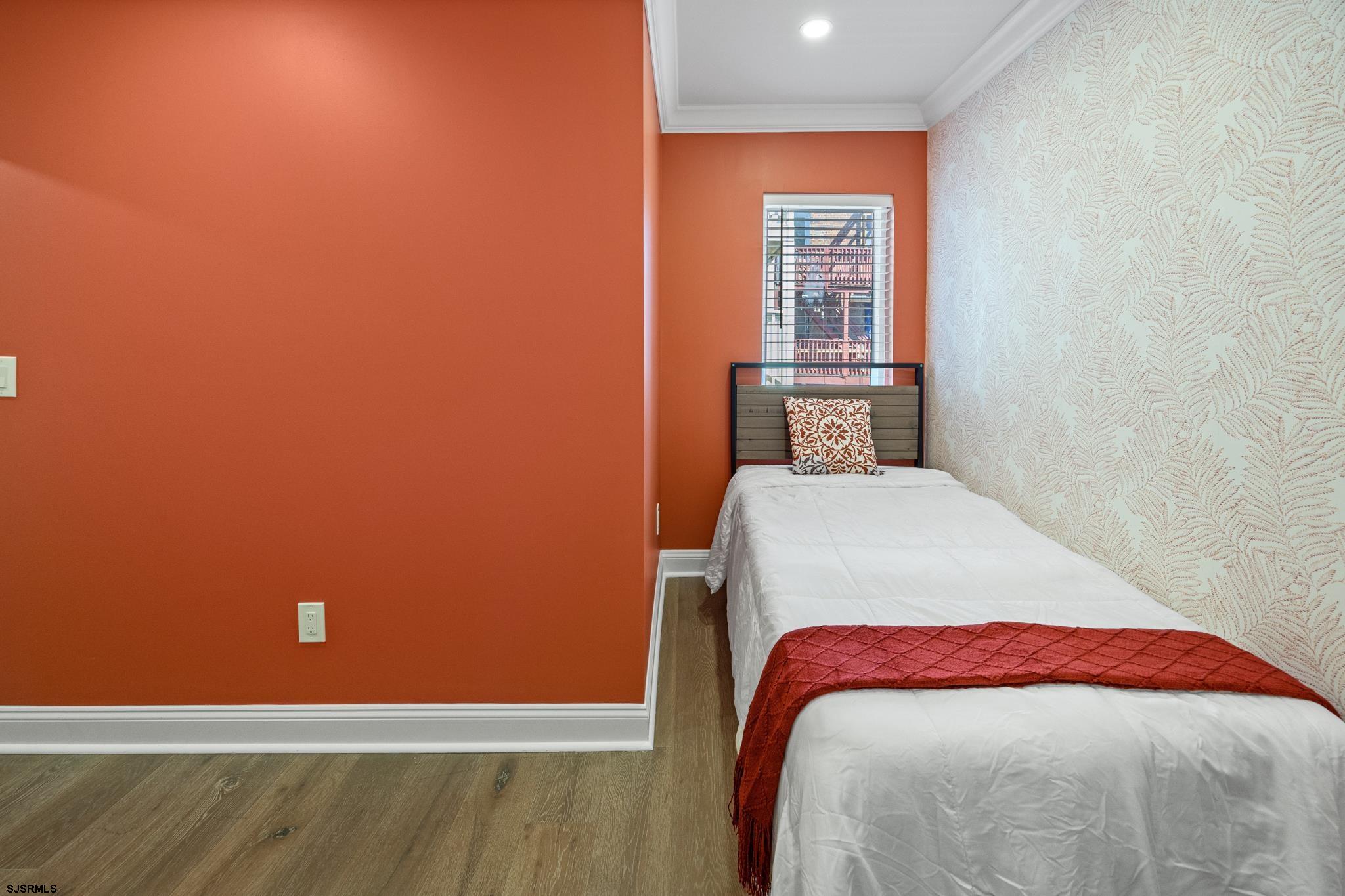 129 Seaside Avenue Atlantic City, NJ 08401 - Photo 17 of 43 a bedroom with a bed and wooden floor