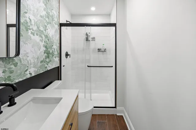 a bathroom with a sink toilet and shower