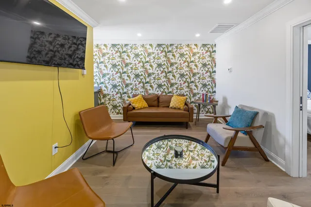 a living room with furniture and a large mirror