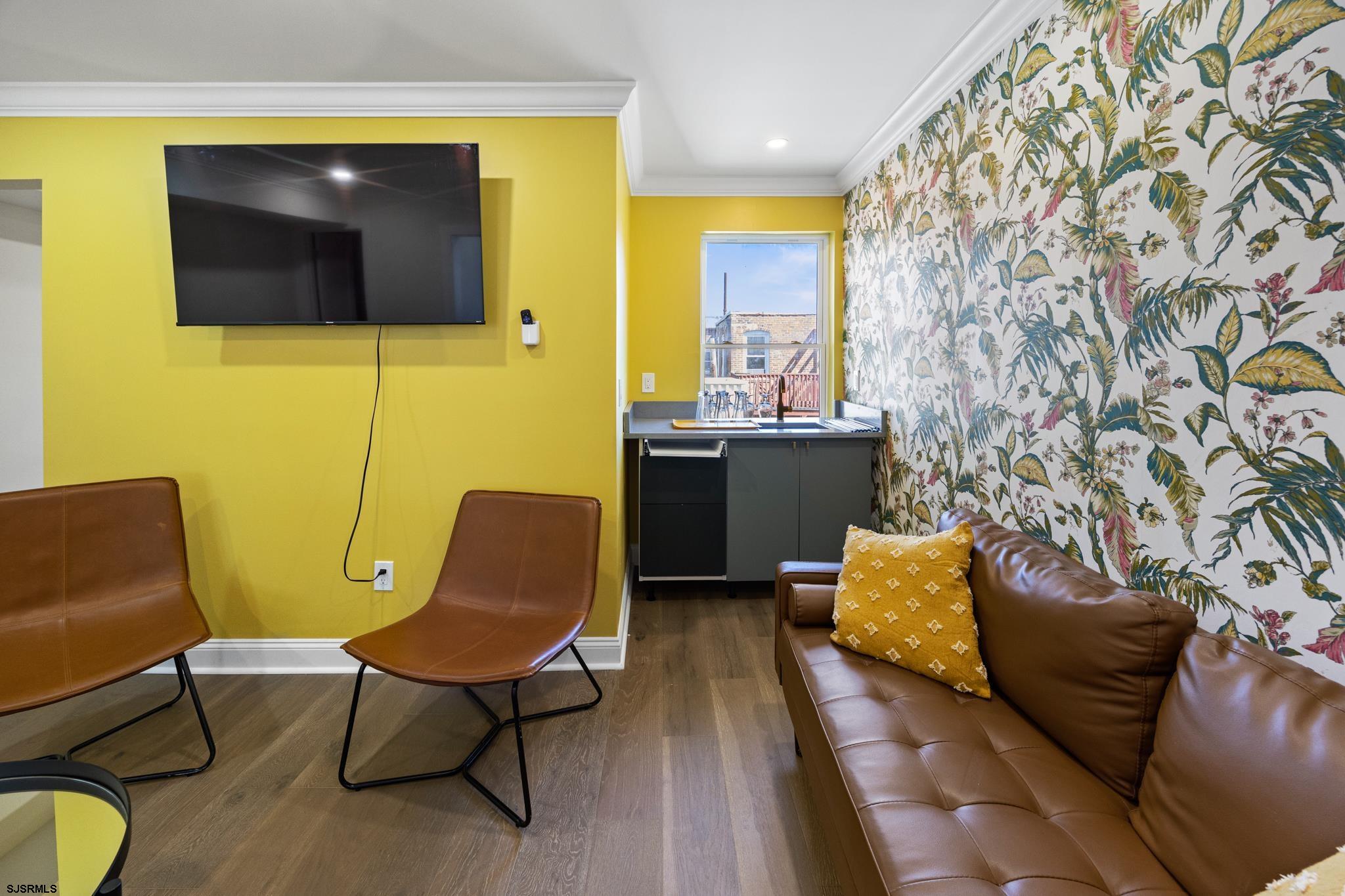 129 Seaside Avenue Atlantic City, NJ 08401 - Photo 26 of 43 a living room with furniture and a flat screen tv