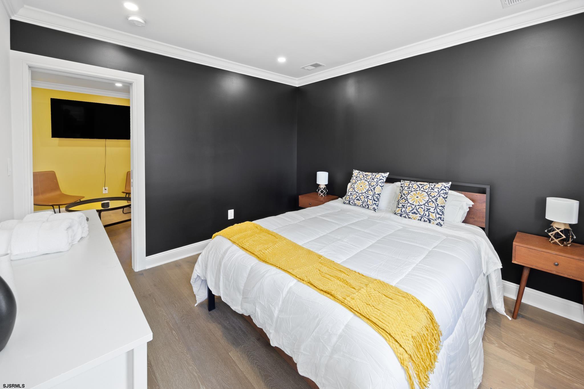 129 Seaside Avenue Atlantic City, NJ 08401 - Photo 30 of 43 a bedroom with a bed and a flat screen tv