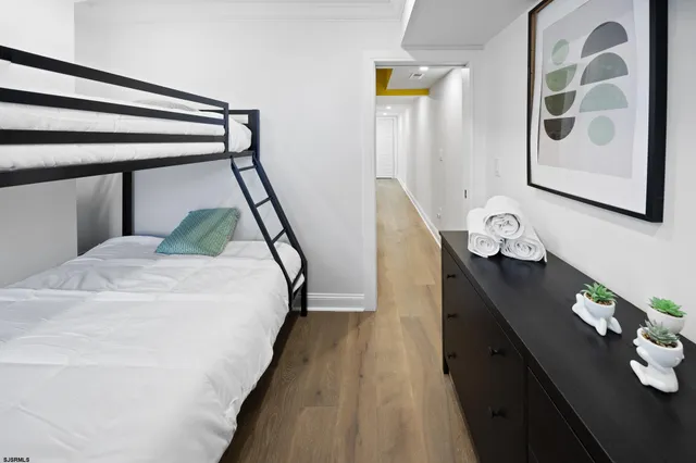 a bedroom with a bed and a potted plant