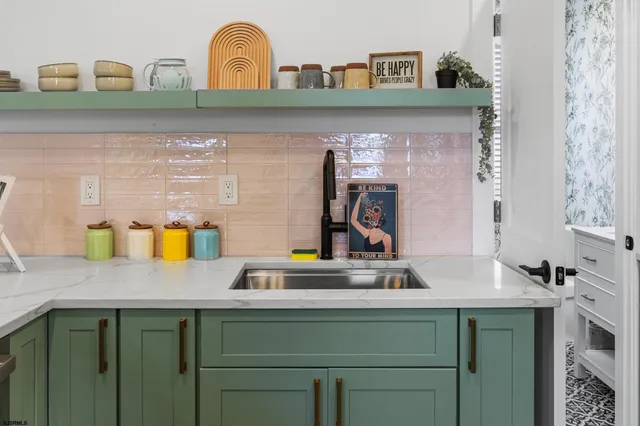 a stove top oven sitting inside of a kitchen
