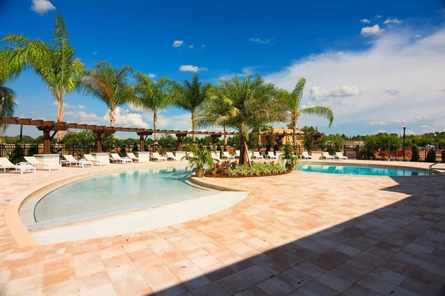 a view of a swimming pool with a table and chairs
