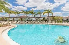 a view of a swimming pool with an outdoor seating