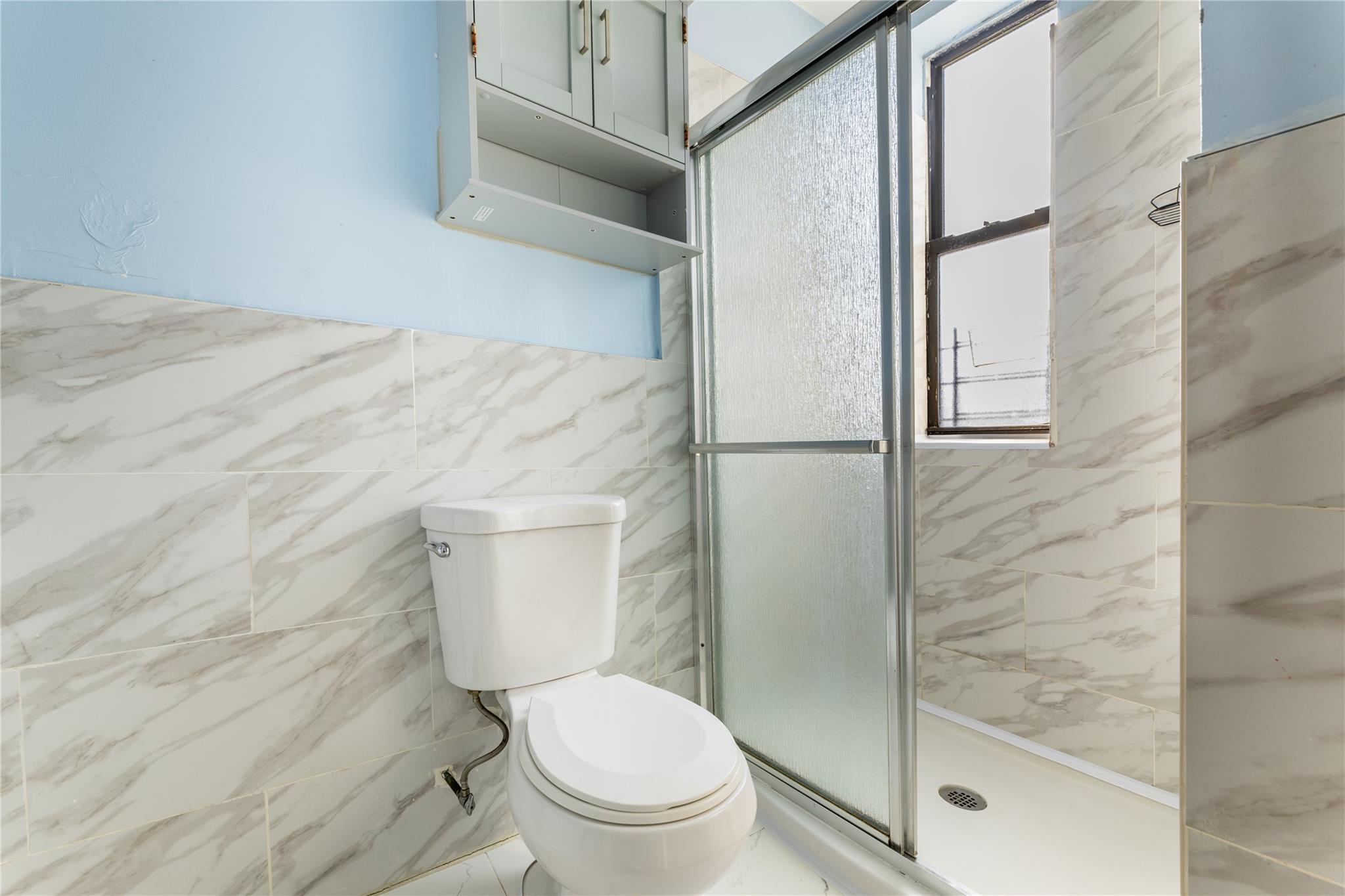 154 South 3rd Street, Unit 24 Brooklyn, NY 11211 - Photo 13 of 17 a white toilet sitting next to a bathroom sink