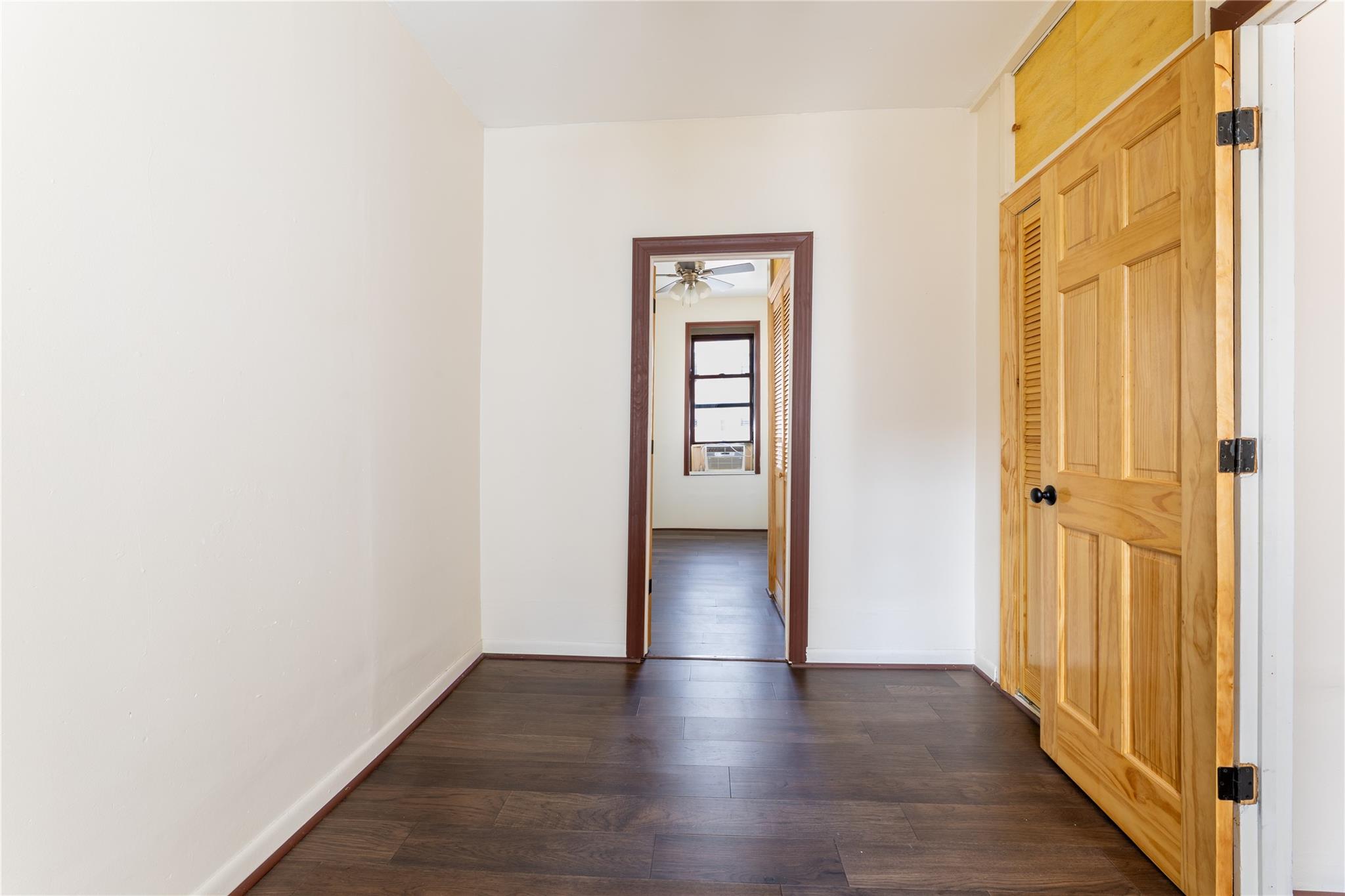 154 South 3rd Street, Unit 24 Brooklyn, NY 11211 - Photo 4 of 17 a view of an empty room with wooden floor and a door