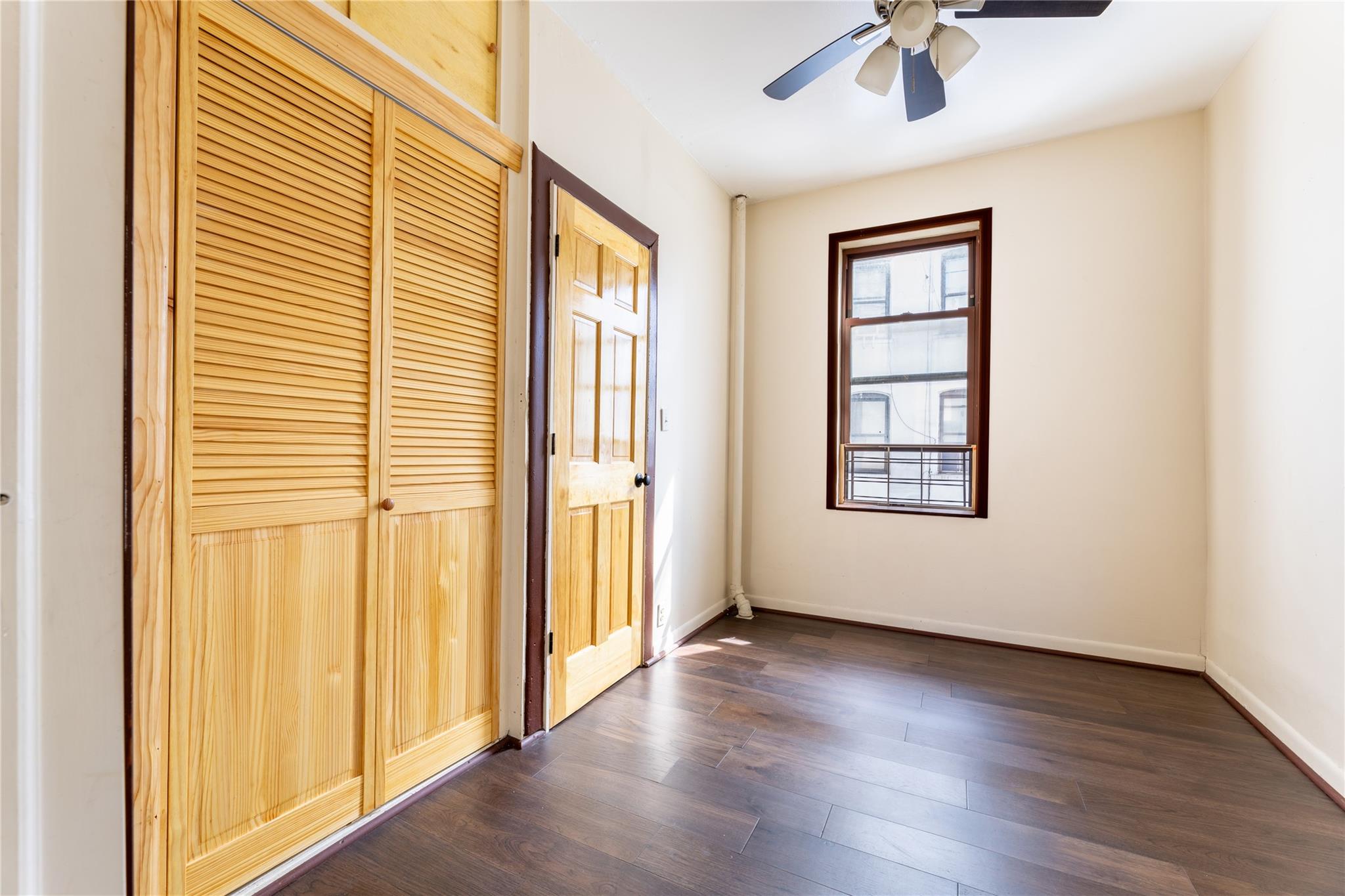 154 South 3rd Street, Unit 24 Brooklyn, NY 11211 - Photo 6 of 17 a view of an empty room with a window and wooden floor