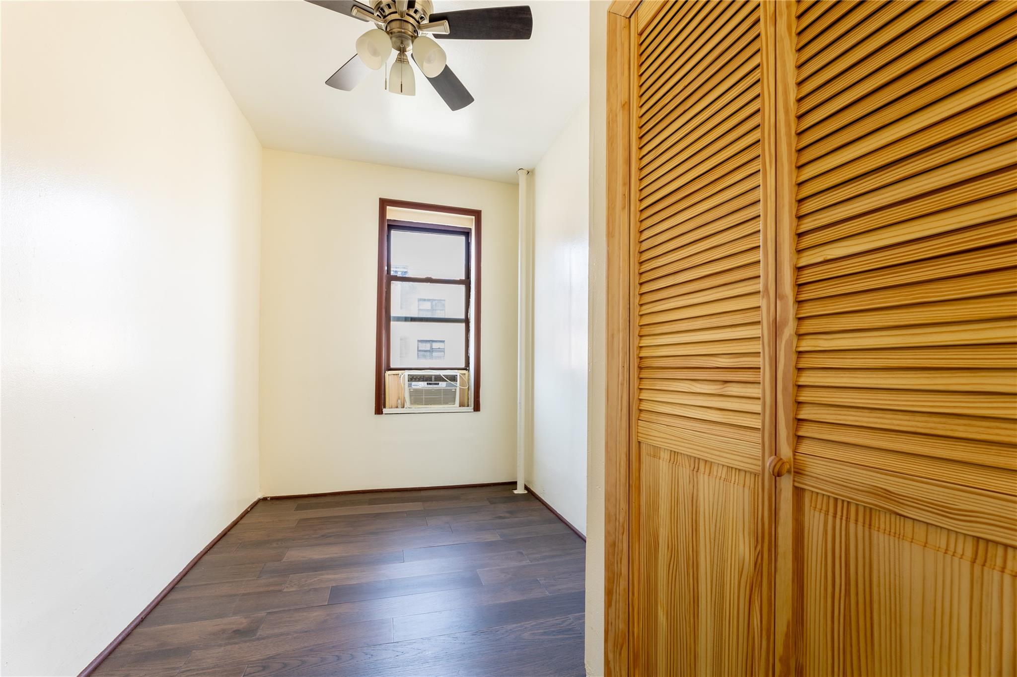 154 South 3rd Street, Unit 24 Brooklyn, NY 11211 - Photo 7 of 17 an empty room with wooden floor fan and windows
