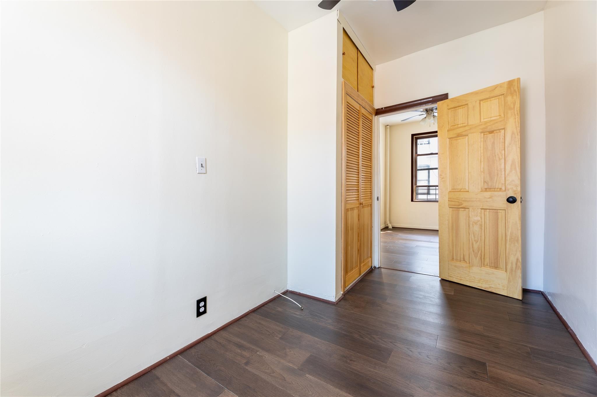 154 South 3rd Street, Unit 24 Brooklyn, NY 11211 - Photo 8 of 17 an empty room with wooden floor and windows