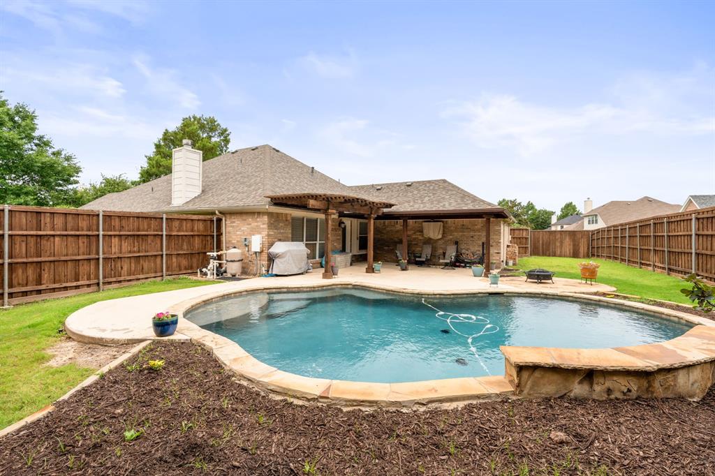 205 Crepe Myrtle Lane Murphy, TX 75094 - Photo 4 of 33 a view of a swimming pool with a lounge chair