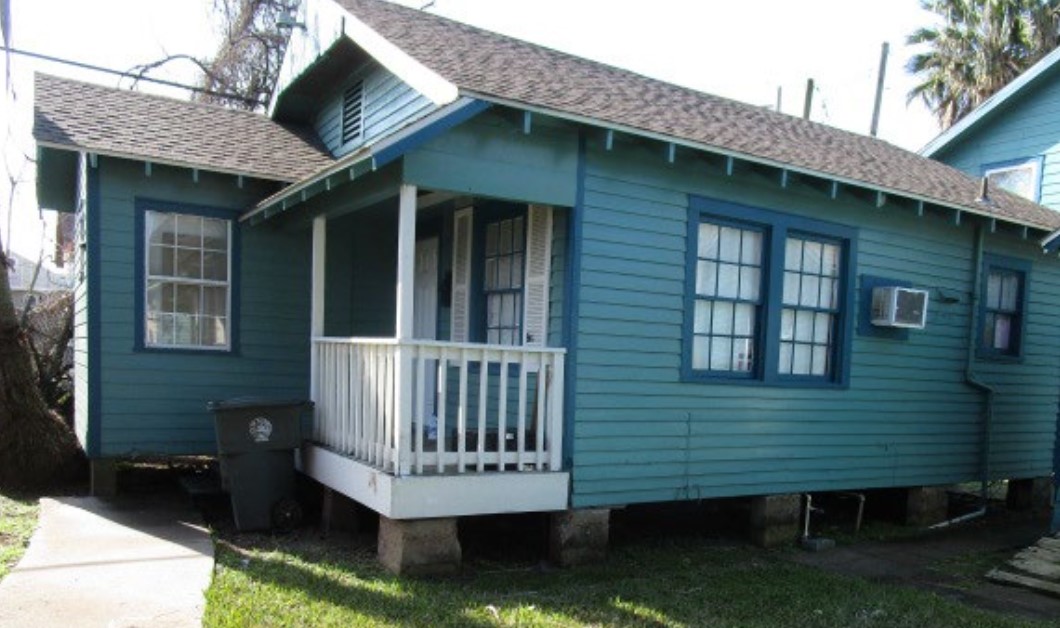 a view of a house with a deck and furniture