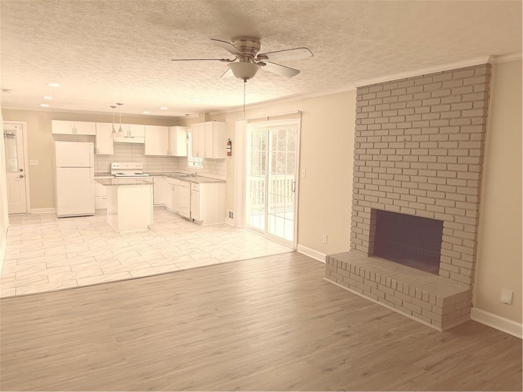 4707 Riverwood Circle Decatur, GA 30035 - Photo 8 of 17 a view of a kitchen with wooden floor and a fireplace