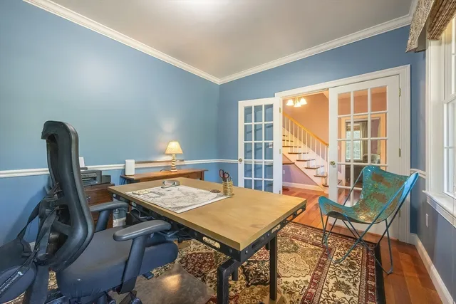 a view of a workspace with furniture and a window