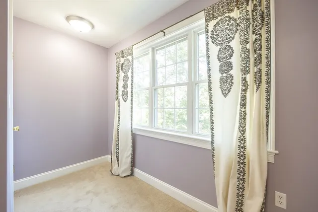 a view of a hallway with wooden floor and livingroom with furniture