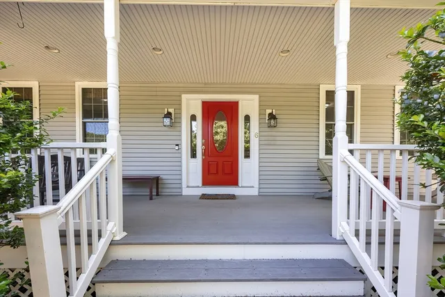 a view of entrance gate of a house with wooden stairs