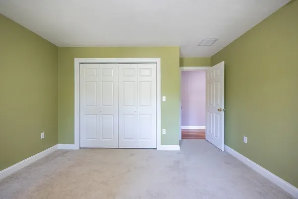 a view of a room with furniture and a window