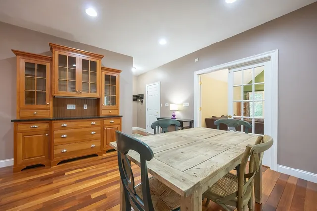 a dining room with a table chairs and wooden floor
