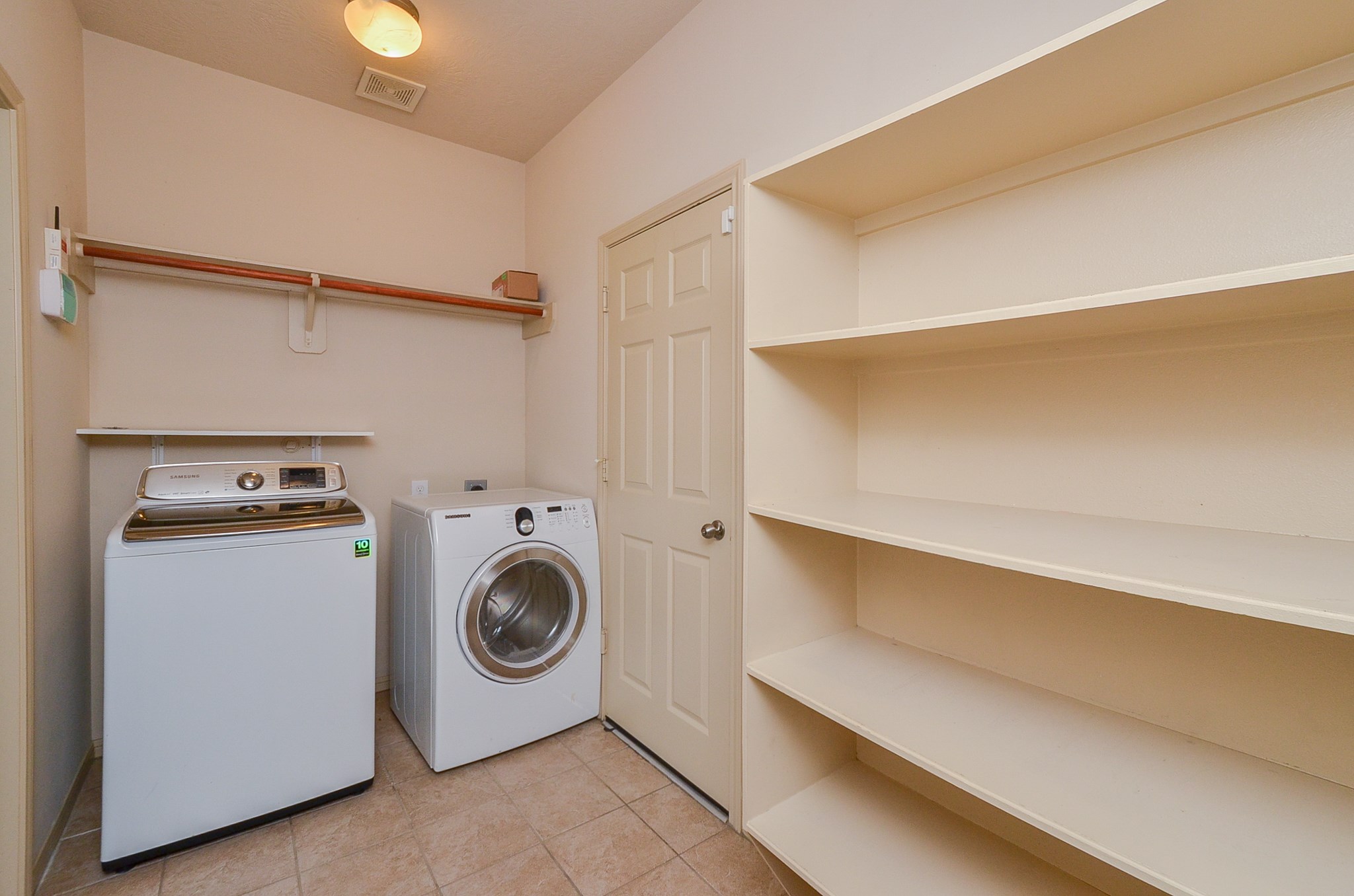 25135 Ginger Ranch Drive Katy, TX 77494 - Photo 14 of 32 A dedicated laundry room includes shelving for storage and space for full-size washer and dryer.