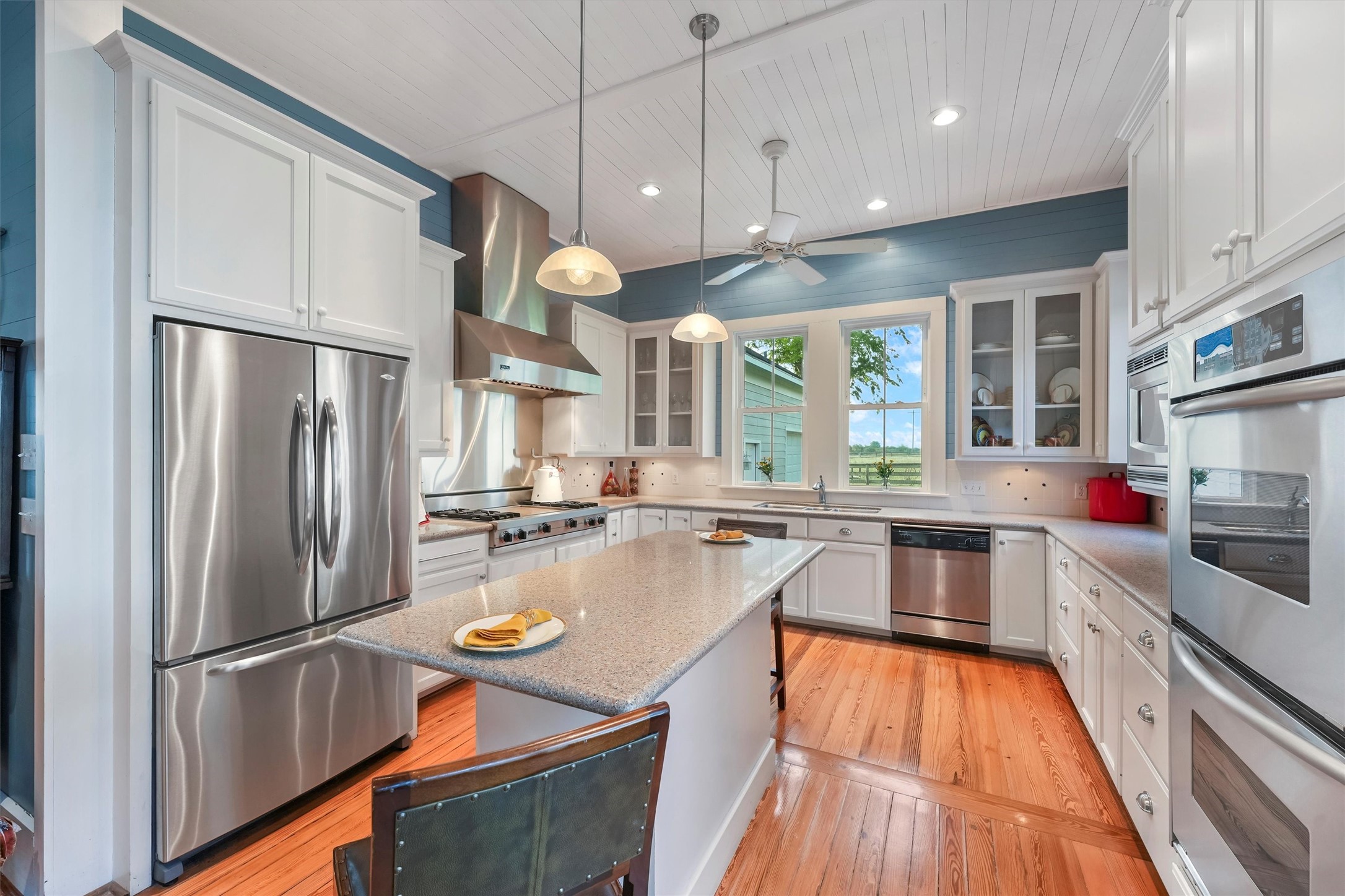 9058 Sam Houston Road Brenham, TX 77833 - Photo 14 of 50 a kitchen with a refrigerator a sink and cabinets