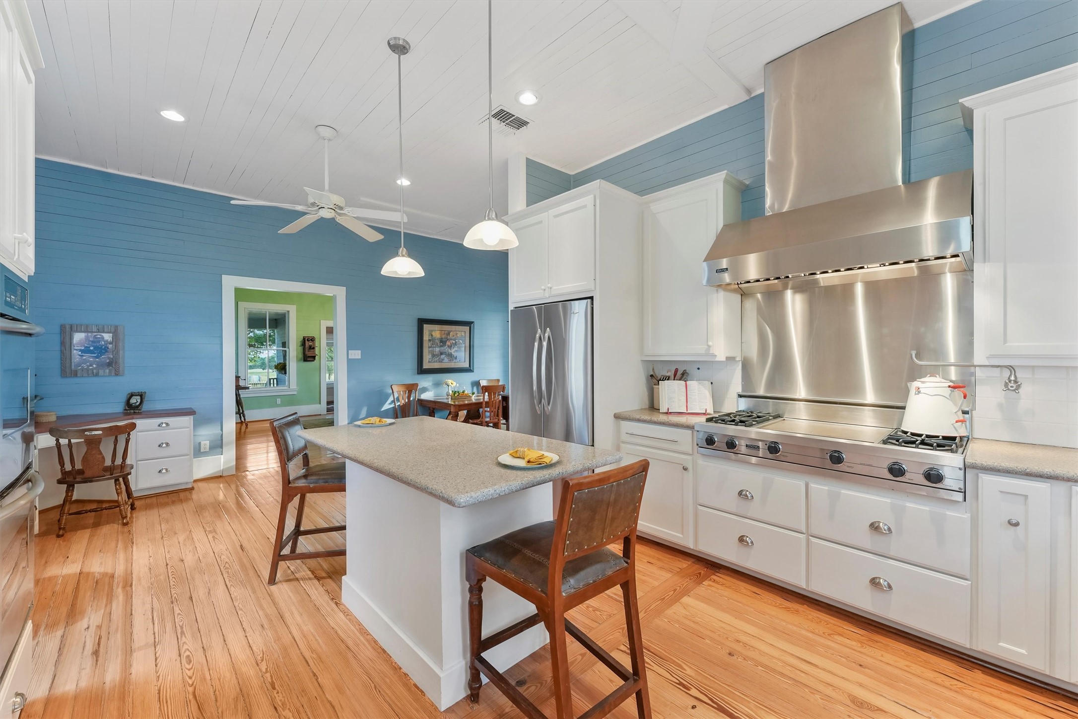 9058 Sam Houston Road Brenham, TX 77833 - Photo 15 of 50 a kitchen with stainless steel appliances a dining table chairs stove refrigerator and cabinets