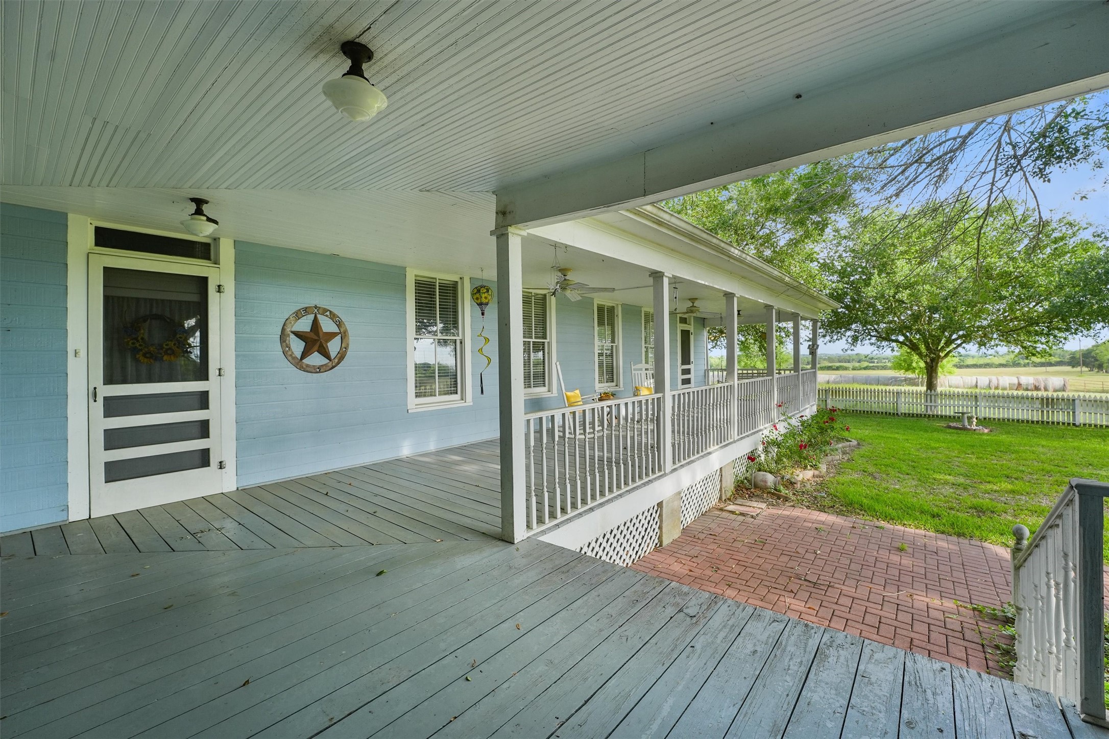 9058 Sam Houston Road Brenham, TX 77833 - Photo 43 of 50 a view of a porch with wooden floor and fence
