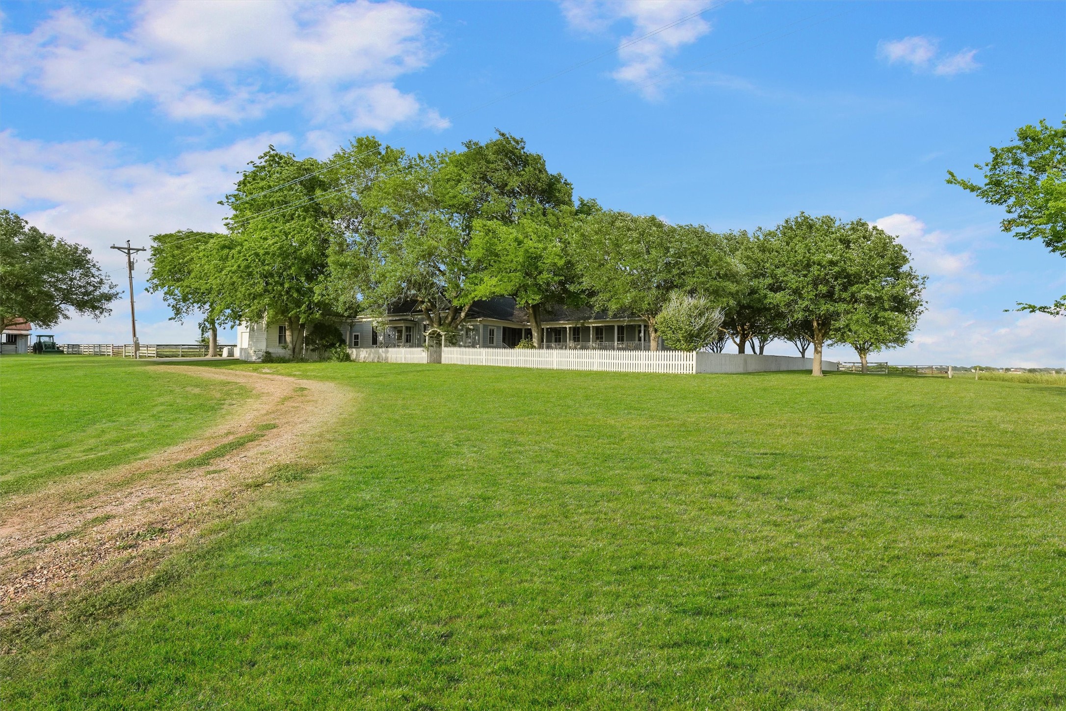 9058 Sam Houston Road Brenham, TX 77833 - Photo 5 of 50 a view of a park with large trees and a houses