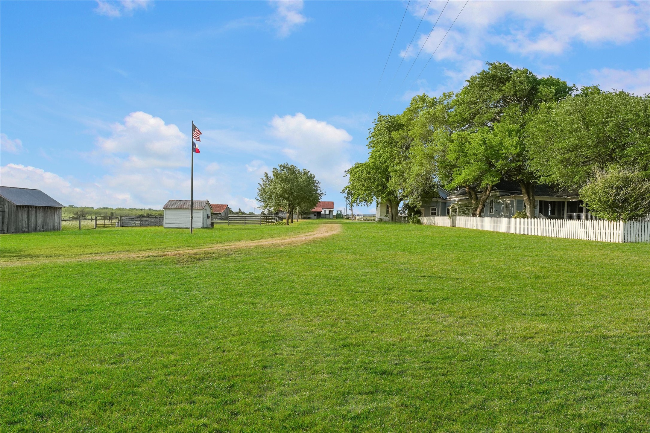 9058 Sam Houston Road Brenham, TX 77833 - Photo 6 of 50 a view of a house with a big yard and palm trees