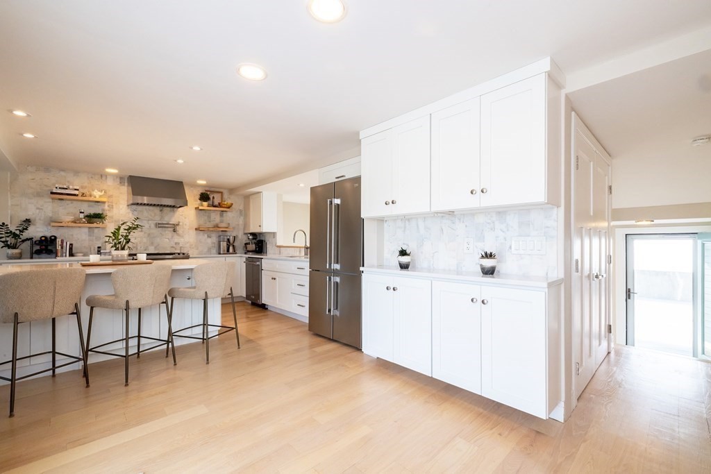 113 Glades Road Scituate, MA 02066 - Photo 14 of 41 a kitchen with white cabinets and stainless steel appliances
