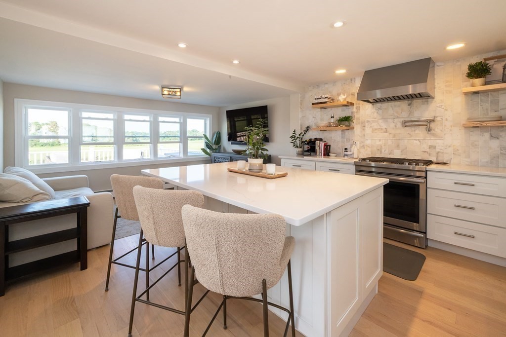 113 Glades Road Scituate, MA 02066 - Photo 19 of 41 a kitchen with stainless steel appliances kitchen island granite countertop a sink and cabinets