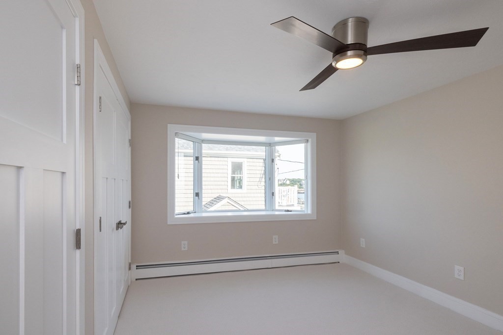 113 Glades Road Scituate, MA 02066 - Photo 24 of 41 an empty room with windows and fan