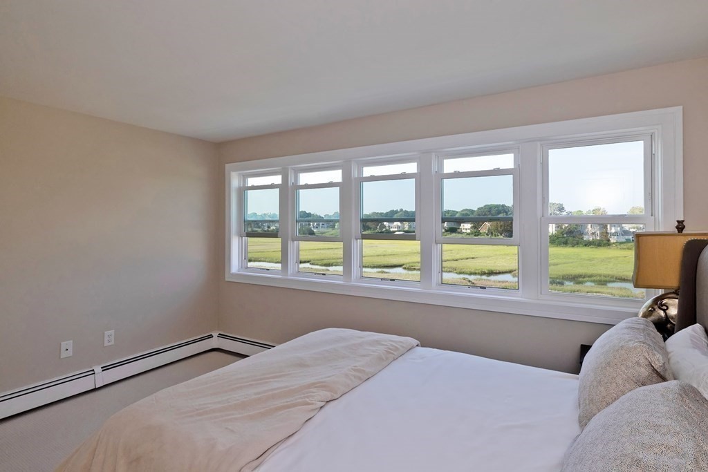 113 Glades Road Scituate, MA 02066 - Photo 26 of 41 a bed sitting in a bedroom next to a window
