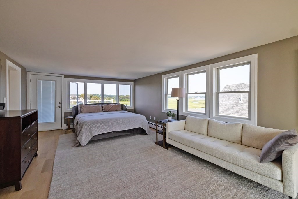 113 Glades Road Scituate, MA 02066 - Photo 33 of 41 a spacious bedroom with a bed couch and a window