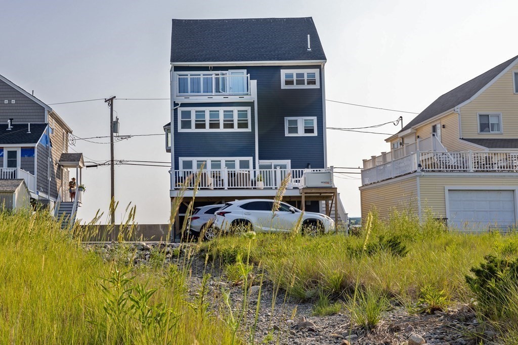 113 Glades Road Scituate, MA 02066 - Photo 8 of 41 a front view of residential houses with yard and trees