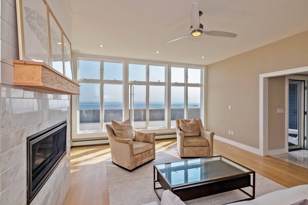 113 Glades Road Scituate, MA 02066 - Photo 9 of 41 a living room with furniture and a fireplace