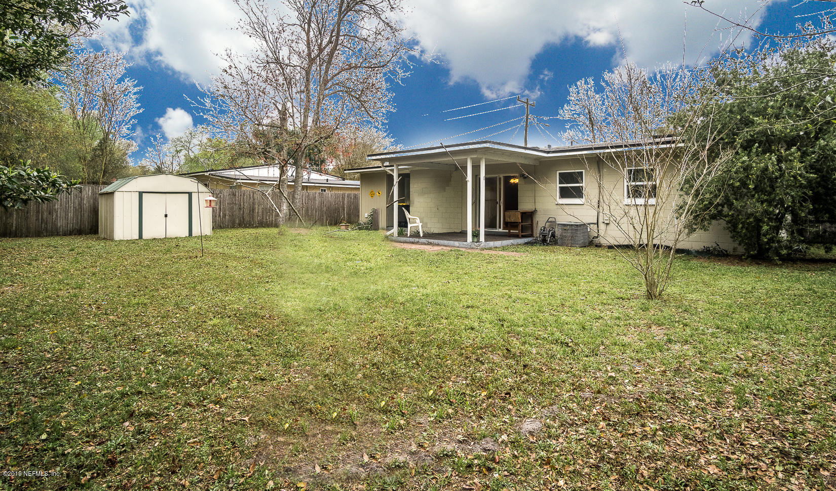 7478 Strato Road Jacksonville, FL 32210 - Photo 5 of 24 a view of a house with a yard and large tree