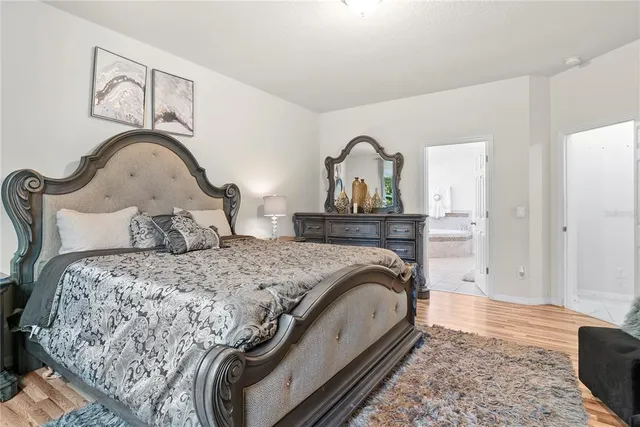 a spacious bedroom with bed and a window