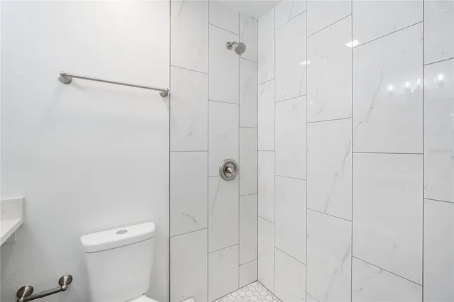 an empty room with a window and ceiling fan