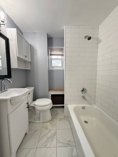 5 Alcott Street, Unit 2 Boston, MA 02134 - Photo 13 of 14 a bathroom with a toilet a sink a mirror and bathtub