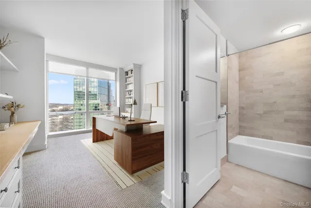 a spacious bathroom with a granite countertop tub shower and view