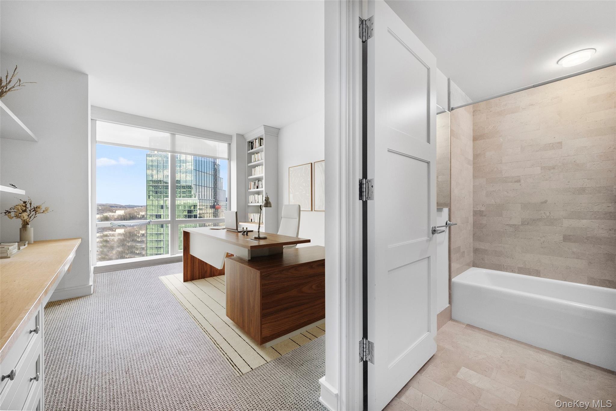 1 Renaissance Square, Unit 12E White Plains, NY 10601 - Photo 14 of 25 a spacious bathroom with a granite countertop tub shower and view