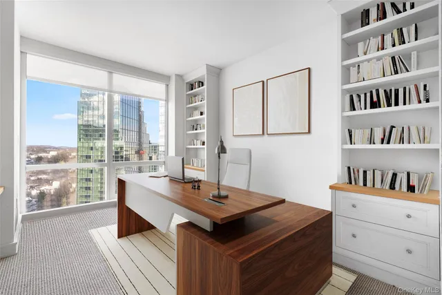 a room with a table chairs and a book shelf