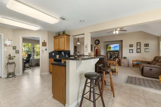 a kitchen with stainless steel appliances granite countertop a stove microwave and cabinets