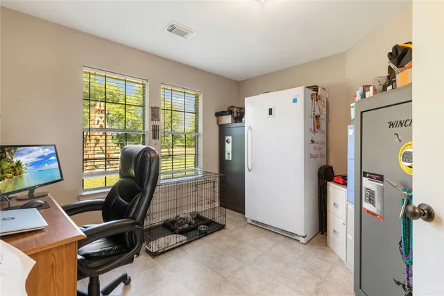 a front view of a house with a garden and lake view