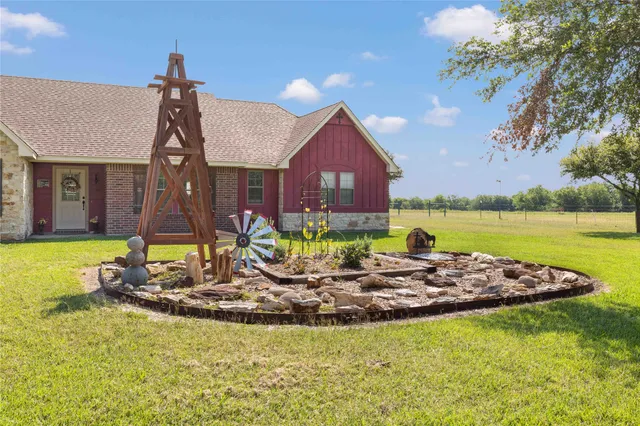 a view of a house with swimming pool and a yard