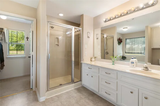a bathroom with a double vanity sink mirror and double