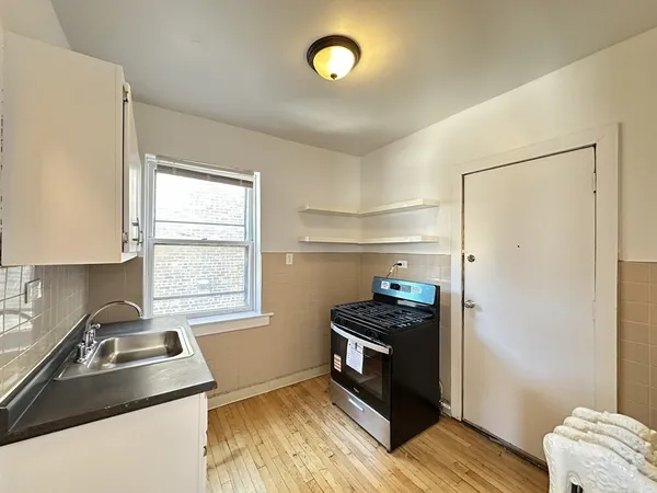 a kitchen with a refrigerator and a sink