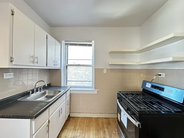 a kitchen that has a sink and a stove