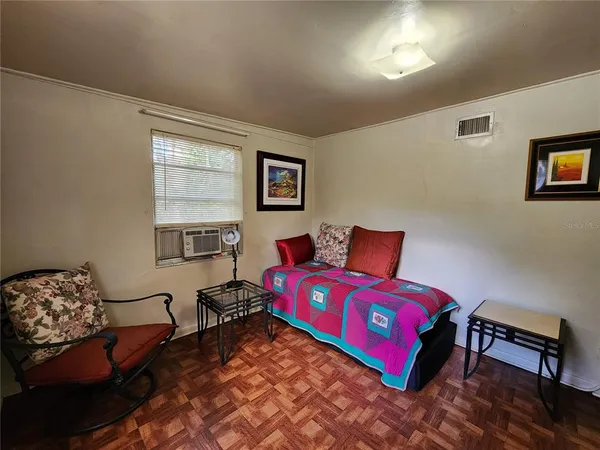 a bedroom with a bed and a couch