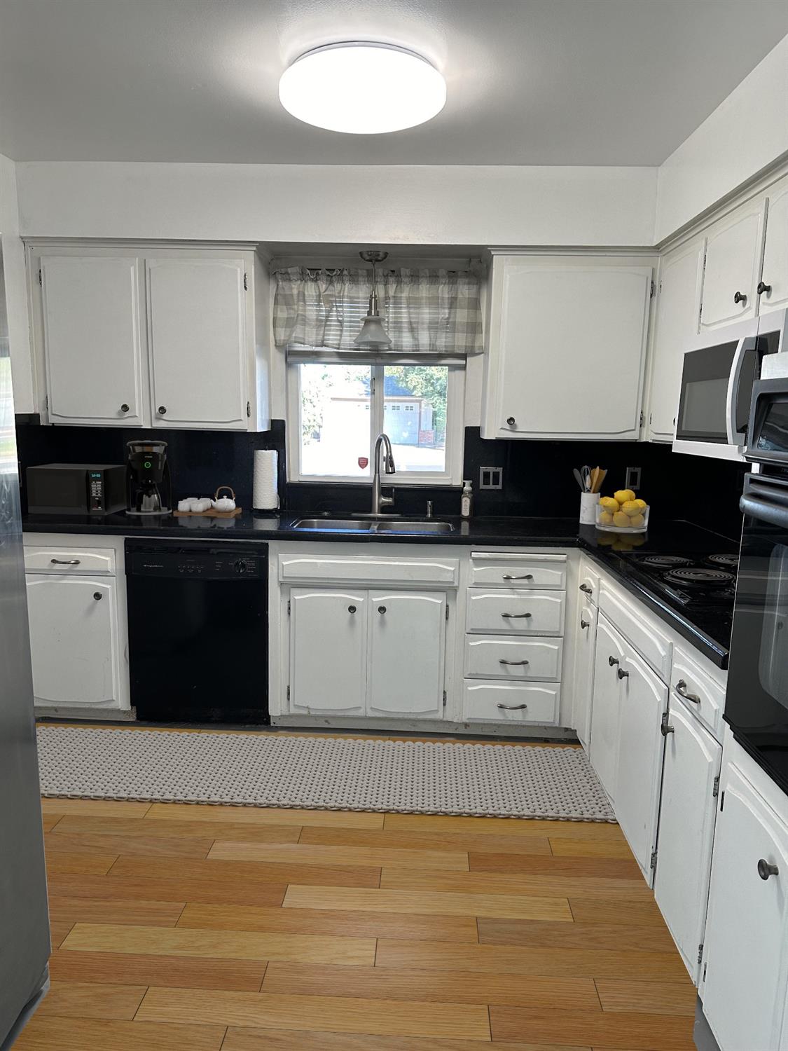 1319 Adler Drive Clovis, CA 93612 - Photo 3 of 20 a kitchen with granite countertop a sink a stove and cabinets